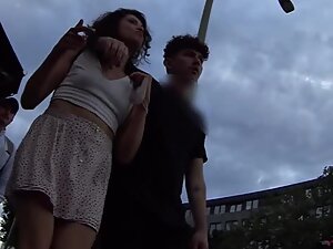 Upskirt of curly girl while boyfriend hugs her