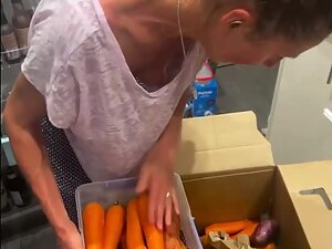 Aunt's tits fall out while she sorts vegetables